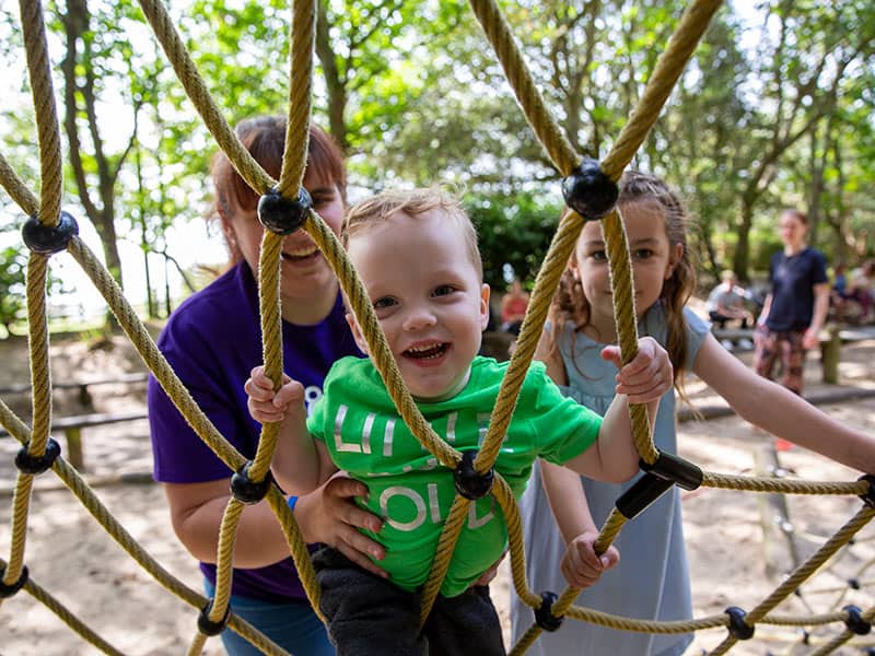 Children and adult lady on climbing ropes